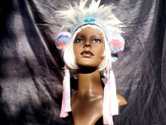 Luxurious feather and pom pom headdress with double tassels and beaded trim. Double layer of feathers. White and turquoise. Ties with a big satin band behind your head. Pom poms on either side with white and pink tassels and gems. Stays on great and very comfortable. Gorgeous braid trim. All our headdresses are handmade with love, no two are the same. The wool for the pom poms is recycled. Bohemian Party Hat With Feathers, Bohemian Party Hats With Feathers, Festival Ostrich Feather Trim Headpiece, Festival Headpiece With Ostrich Feather Trim, Whimsical Blue Costume Hats And Headpieces For Festival, Ostrich Feather Trim Headpieces For Festivals, Bohemian Festival Hats And Headpieces For Carnival, Carnival Festival Costume Hats With Feathers, Bohemian Multicolor Headpieces For Carnival