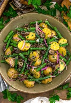 a bowl filled with potatoes and green beans