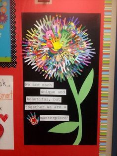 a bulletin board with some writing on it and a flower made out of crayons