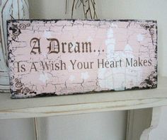 a wooden sign that says, a dream is a wish your heart makes on it