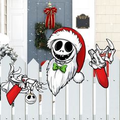 a cartoon skeleton wearing a santa claus hat and holding a christmas ornament in front of a white picket fence