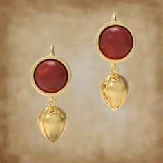 These gorgeous earrings feature as dangle one of the most popular ancient fruits: the pomegranate, symbol of fertility, life, rebirth and power. Here, the solid, ornate dangle hangs beneath a round cabochon stone held in a sleek bezel setting. Our earrings are based on an ancient pair from the first century AD. "Aelia" was the name of plebeian gens active in Rome from the fifth century BC until the third century AD. The emperor Hadrian (r. AD 117 - 138) was among its illustrious members. One fam Byzantine Jewelry With Cabochon For Gifts, Byzantine Cabochon Jewelry For Gifts, Byzantine Style Cabochon Jewelry For Gifts, Byzantine Style Cabochon Jewelry Gift, Elegant Drop Earrings With Cabochon, Byzantine Sterling Silver Jewelry With Matching Earrings, Elegant Handmade Round Pendant Earrings, Traditional Polished Earrings As Gift, Traditional Polished Earrings For Gift