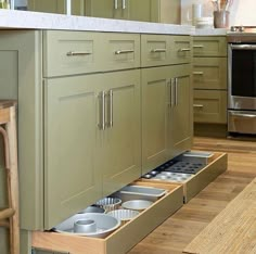 an open drawer in the middle of a kitchen