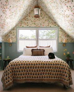 a bed sitting under a window in a bedroom