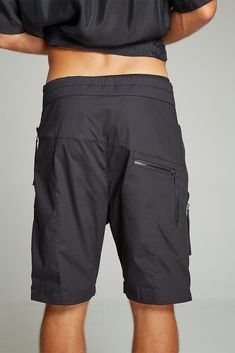 100% stretchy cotton shorts with front zip opening and drawstring belt for the perfect fit. Subtle vertical stitch detailing, long side zip pockets with leather detail and inner secondary pockets to keep valuable items safe. Low back zip pocket with leather detail. All zippers decorated with leather string. • 100% cotton Small size Width - 41 cm, Length - 53 cm. Medium size Width - 43 cm, Length - 54 cm. Large size Width - 45 cm, Length - 53 cm. Short Hiking Pants With Side Pockets, Techwear Short Bottoms For Hiking, Techwear Shorts For Hiking, Techwear Hiking Shorts, Sporty Cargo Shorts, Functional Short Bottoms With Cargo Pockets, Black Cotton Hiking Bottoms, Black Short-length Cargo Pants For Outdoor Activities, Functional Short Bottoms With Hip Pockets