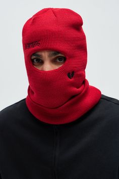 a man wearing a red ski mask