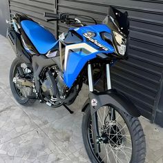 a blue motorcycle parked next to a building