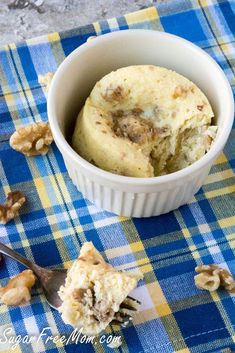 a white bowl filled with food on top of a blue and yellow checkered table cloth