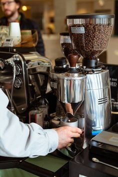 a coffee maker is being used to make espresso in a restaurant or bar