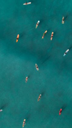 several small boats floating in the blue water