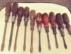 an assortment of woodworking tools are lined up on a white plate with black trim