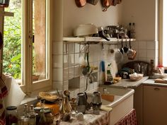 a kitchen with pots and pans hanging from the ceiling