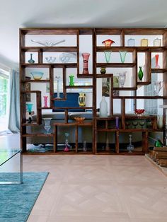 a living room filled with lots of wooden shelves