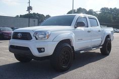 a white toyota truck parked in a parking lot