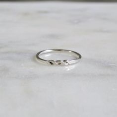 The delicate lace-like openings in this ring are created by twisting and hammering two strands of metal. With its light elegance and hand-forged charm, this dainty ring is perfect for stacking with others or wearing by itself. - Sterling silver with a high shine finish - Central motif is approximately 10mm x 2.3mm; 1.3mm band - Crafted with joy in San Francisco Sample ring shown in a size 7. Available in half sizes 3 through 13 (and 1 through 16 by special request). Each order comes in a drawstr Light Elegance, Liberty Of London Fabric, Zierlicher Ring, Twist Ring, Ring Stacking, Liberty Of London, Dainty Ring, Stacking Ring, Gold Filled Jewelry