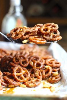 a spoon full of pretzels sitting on top of a table