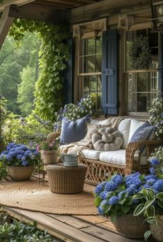 a porch with wicker furniture and blue flowers