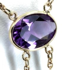 "Vintage Minimalist Lavalier Necklace in 14k Gold with Bezel Set, Oval Cut, Amethysts. This necklace bears a makers hallmark with \"rings and the letter A\", there is also a 14k Purity mark, no origin mark. Necklace measures 15.75\" Total Drop of Lavalier Pendant 1.75\" 1X - 13.6x9.8x5.85 mm Large Amethyst Oval Gem 2X - 7x4.5x3.75 mm Small Amethyst Oval Gems Total weight of necklace 0.179 Oz (78.1 g) This item is vintage. It has been cherished, worn, and preserved by possibly many over the decad Dainty Briolette Necklace For Formal Occasions, Formal Briolette Jewelry With Delicate Chain, Formal Briolette Necklace With Bezel Setting, Delicate Oval Pendant Necklace For Formal Occasions, Formal 14k Gold Necklace With Bezel Setting, Delicate Oval Necklace For Formal Occasions, Delicate Hallmarked Necklaces For Formal Occasions, Minimalist Gemstone Necklace For Formal Occasions, Dainty Gemstone Necklace For Formal Occasions