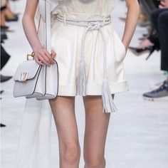 Valentino's Ivory Leather Shorts Appeared On The Ethereal Ss20 Runway Which Revolved Around The Colour White, Recalling Codes From The House's 1968 Offering. They're Expertly Crafted In Italy With Stitched Waist Pleats To Create A Flared, Structured Shape Which Leads To Neat Turned-Up Cuffs. Tuck In A Voluminous Blouse To Tap The Collection's Dramatic Styling. 100% Leather Belt Not Included Elegant Shorts With Belt Loops For Spring, Elegant Spring Shorts With Belt Loops, Luxury Beige Bottoms For Spring, Luxury Short Bottoms For Spring, Luxury Short Spring Bottoms, Luxury Short Length Bottoms For Spring, Luxury Short Length Spring Bottoms, Chic White Bermuda Shorts, Elegant White Summer Shorts