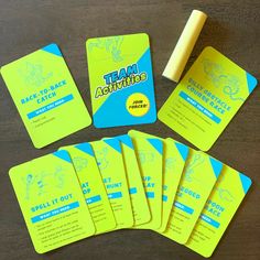 a group of yellow cards sitting on top of a wooden table