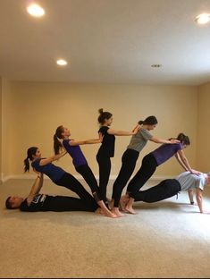 a group of people standing in a circle on the floor