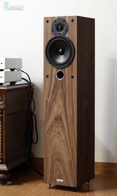 a speaker sitting on top of a wooden floor