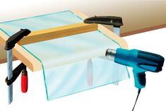 an image of a drill and some tools on a table with a sheet of paper