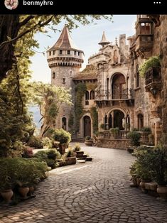 an old castle like building is surrounded by greenery and cobblestone walkways