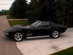 a black sports car parked on the side of a road