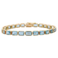 Aquamarine bracelet in 18K Gold. It has a perfect octagon cut gemstone to make you stand out on any occasion or an event. A tennis bracelet is an essential piece of jewelry when it comes to your wedding day. The sleek and elegant style complements the attire beautifully, whether it's the bride wearing it herself, or as a gift to her bridesmaids to wear on the D’day. PRODUCT DETAILS :- Material - 18K Solid Yellow Gold Gemstone - Aquamarine Stone Weight - 12.4 ct Stone Shape - Octagon Stone Pcs - Luxury Yellow Gold Rectangular Tennis Bracelet, Luxury Yellow Gold Emerald Cut Bracelet, Yellow Gold Emerald Cut Tennis Bracelet For Formal Occasions, Emerald Cut Yellow Gold Tennis Bracelet For Formal Events, Emerald Cut Yellow Gold Tennis Bracelet For Formal Occasions, Formal Yellow Gold Emerald Cut Tennis Bracelet, Formal Rectangular Bracelet In Fine Jewelry Style, Rectangular Bracelet For Formal Occasions, Fine Jewelry, Fine Jewelry Rectangular Bracelet For Formal Occasions