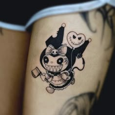 a person with a tattoo on their leg that has a cartoon character and jack - o'- lantern