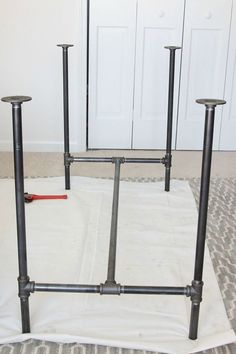 two metal poles sitting on top of a rug