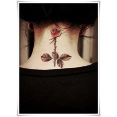 a woman's neck with a rose tattoo on her left side ribcage