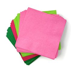 pink and green napkins stacked on top of each other