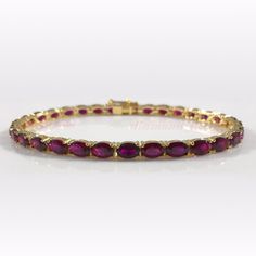 This elegant, genuine deep dark red tennis bracelet is encircled with luscious oval ruby red wine colored stones. Yellow gold protects the pure silver underlay. The bracelet is secured by a box and tongue with safety clasp and crafted of sterling silver. Total gem weight: 18ct. A truly timeless piece.   Product Details Metal Type:sterling-silver Clasp Type:box-with-tongue-and-safety Metal Stamp:925-sterling Chain Type:other-chain-type Length:7.5 IN Width:4.2 MM Length: 6 MM Stone Details Stone Weight:18ct Shape:oval-shape Setting:prongs Stone Weight:18ct Shape:oval-shape Setting:prongs Treament: Diffusion, heat, radiation, filling, compression, pressure. The base stone is resin filled to remove cracks. We use natural stones that have treatment to increase appearance to nearly flawless ston Colored Stones, Fashion Event, Wine Colored, Tennis Bracelet, Ruby Red, Chain Link Bracelet, Metal Stamping, Pure Silver, Oval Shape