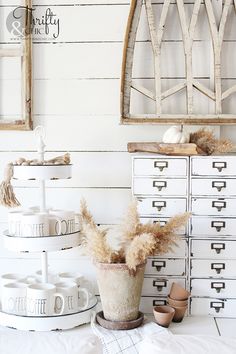 a white dresser and some drawers in a room