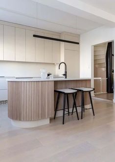 two stools sit in front of a kitchen island