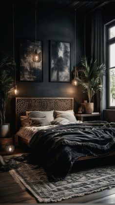 a bedroom with black walls, large bed and potted plants on the side table