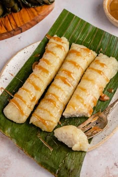 some food is sitting on a plate with a fork and spoon next to it,