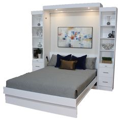 a white bed with built in bookcases and pillows