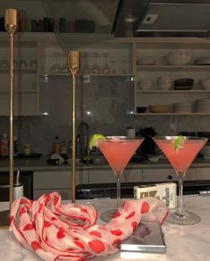 two martinis on a kitchen counter with a red and white scarf