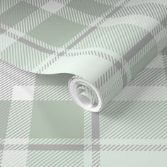 a green and white checkered wallpaper with a rolled up roll on it's side