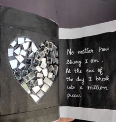 an open book with a heart shaped mirror on the cover and words written in it