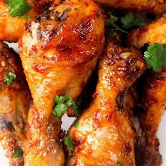 some chicken wings with parsley on top of them