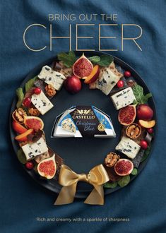 the cover of bring out the cheer magazine with an assortment of cheeses and fruit