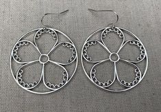 These are so unique and cool!  Big silver flower hoop earrings.  They are modern and whimsical.  Eye catching and versatile.  Dress them up or down.  The earrings measure 1 3/8” long by 1 3/8” wide and are made from plated silver.  They hang from simple silver ear wire hooks.  Overall drop length is 1 1/2”.I have a matching necklace in my shop if you would like the whole set.  Here is a direct link.........Thanks for stopping by!  Please take a moment and visit the rest of my Etsy store.  I have Hypoallergenic Flower Earrings For Spring, Spring Hoop Earrings With Flower Charm As Gift, Spring Hoop Earrings As Gift, Handmade Small Hoop Earrings For Spring, Small Hoop Earrings For Spring Season As A Gift, Small Hoop Jewelry For Spring Gift, Silver Round Earrings For Spring, Small Hoop Earrings For Spring Gift, Spring Hypoallergenic Flower Earrings