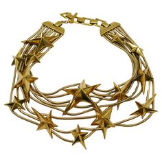 THIERRY MUGLER vintage gold tone multi strand snake chains choker necklace embellished with THIERRY MUGLER's iconic stars. Adjustable T-bar and toggle closure. Embossed THIERRY MUGLER and TM. Indicative measurements : adjustable length from approx. 32 cm (12.60 inches) to approx. 35 cm (13.78 inches). Material : Gold tone hardware. NOTES - This is a preloved vintage item, therefore it might have imperfections. - Colors may differ slightly from actual product appearance due to differences in lighting conditions. - As a buyer, you are fully responsible for customs duties, other local taxes and any administrative procedures related to imports into the country of destination. Vintage Choker Necklace, Star Motif, Vintage Choker, Thierry Mugler, Gold Choker, Chain Choker Necklace, Cool Necklaces, Gothic Jewelry, Chain Choker