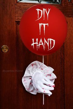 a red balloon with the words diy it hand on it hanging from a door