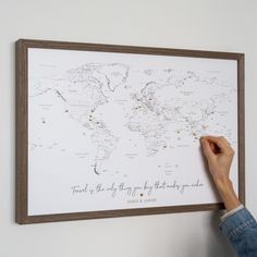 a person is holding up a map with words on it and writing in the middle