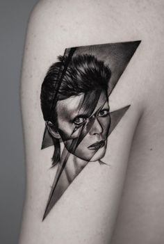 a black and white photo of a woman's shoulder with an abstract portrait on it